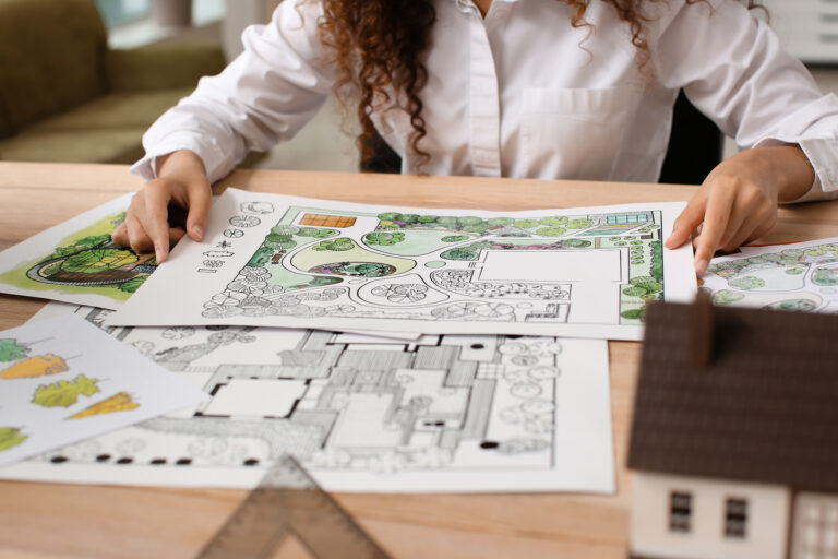 Young Female Landscape Designer Working In Office