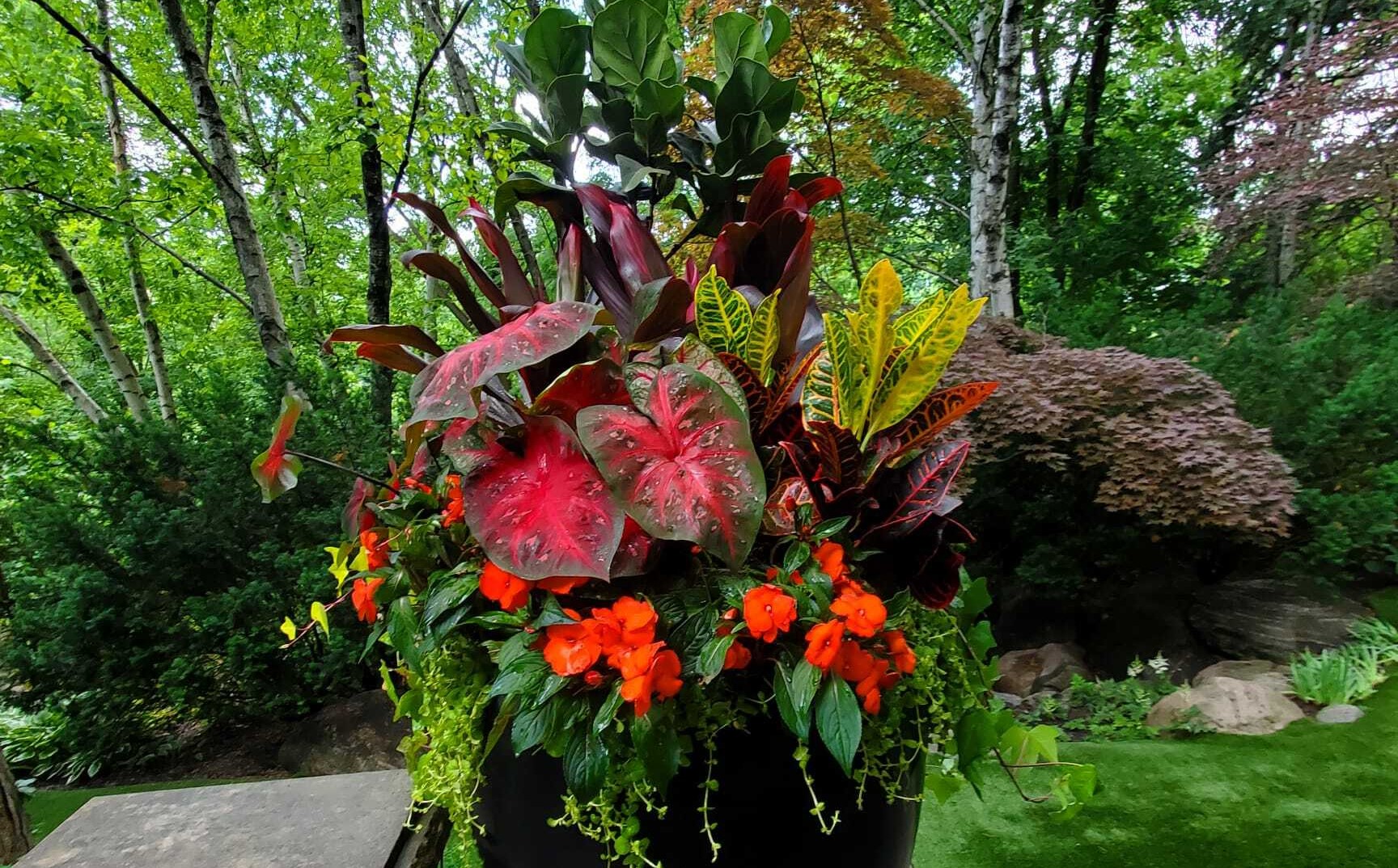landscaping with seasonal urn planter with flowers in toronto