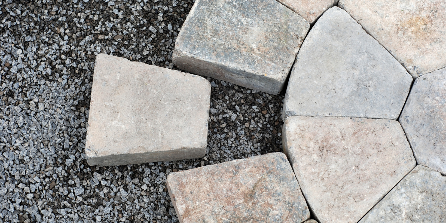 Interlocking Stones being placed in a round shape - Unlocking the Beauty of Custom Interlock Stonework: Your Questions Answered